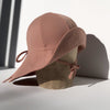 US stockist of Fini the Label's gender neutral, floppy swim hat in cocoa. Features elongated back for added sun protection, chin strap and adjustable bow around crown for better fit. Brim is medium stiffness and can be flipped up at front.  Made from nylon/spandex and is quick drying.