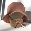 US stockist of Fini the Label's gender neutral, floppy swim hat in cocoa. Features elongated back for added sun protection, chin strap and adjustable bow around crown for better fit. Brim is medium stiffness and can be flipped up at front.  Made from nylon/spandex and is quick drying.