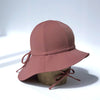 US stockist of Fini the Label's gender neutral, floppy swim hat in marsala. Features elongated back for added sun protection, chin strap and adjustable bow around crown for better fit. Brim is medium stiffness and can be flipped up at front.  Made from nylon/spandex and is quick drying.