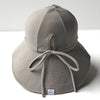US stockist of Fini the Label's gender neutral, floppy swim hat in mushroom. Features elongated back for added sun protection, chin strap and adjustable bow around crown for better fit. Brim is medium stiffness and can be flipped up at front.  Made from nylon/spandex and is quick drying.
