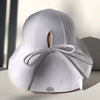 US stockist of Fini the Label's gender neutral floppy swim hat in white. Features elongated back for added sun protection, chin strap and adjustable bow around crown for better fit. Brim is medium stiffness and can be flipped up at front.  Made from nylon/spandex and is quick drying.