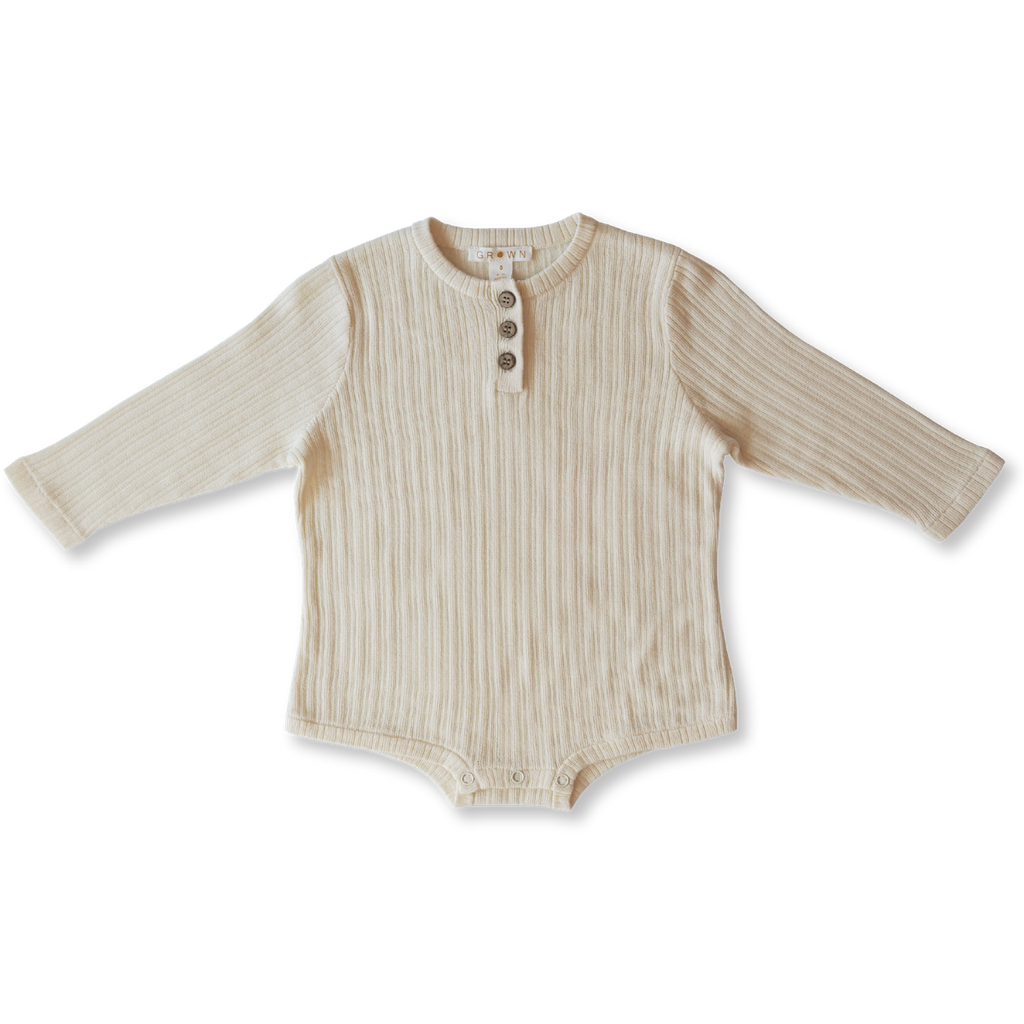 US stockist of Grown Clothing's gender neutral, organic cotton ribbed button bodysuit in Milk.