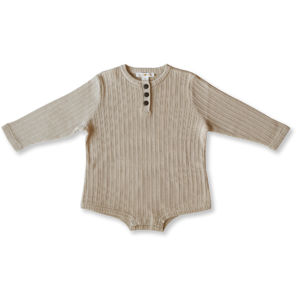 US stockist of Grown Clothing's gender neutral, organic cotton ribbed button bodysuit in Natural.