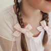 US stockist of Josie Joan's Charlie classic bow clip.  Made from cotton/linen in a shade of soft pink.