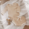 US stockist of India + Grace The Label's gender neutral, beige long sleeved ribbed cotton bodysuit.  Features crotch snap.