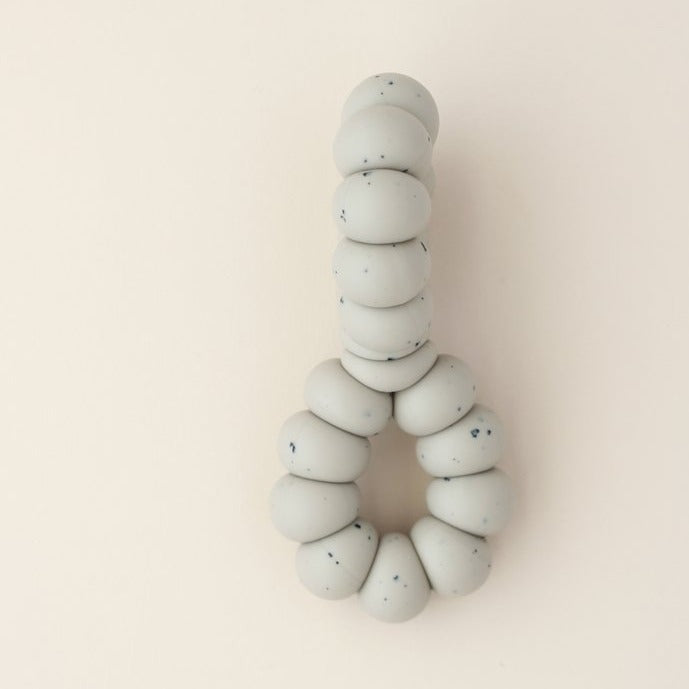 US stockist of Little Chew's gender neutral, Infinity Taupe freezer toy.  Pop in the fridge to help soothe those sore gums.