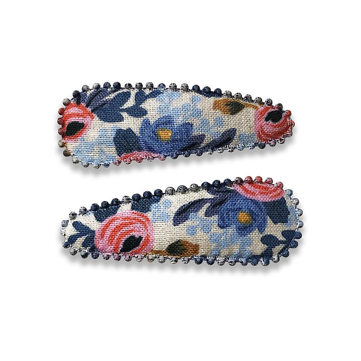 US stockist of Josie Joan's Joan set of two fabric hair clips.  Cream colored fabric with blue and pink flowers with contrasting blue leaves.  Features scalloped edges.