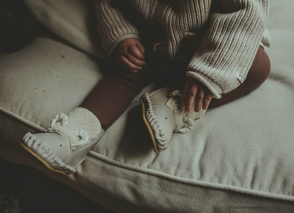 US stockist of Donsje's light grey, leather ram baby shoes with Kapi exclusive faux fur lining.  Velcro fastening - soft sole under 12mths.