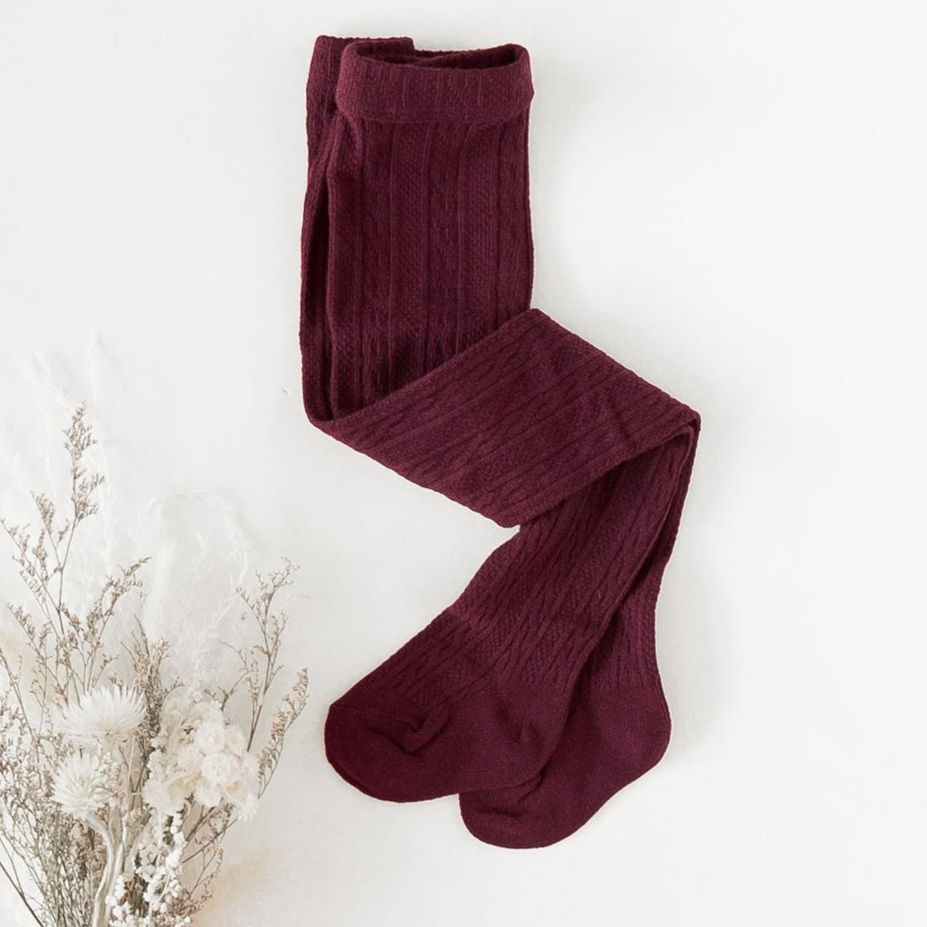 US stockist of Karibou Kids' Rosie Cozy Cable Knit Tights in Plum.  Made from a stretch cotton blend.