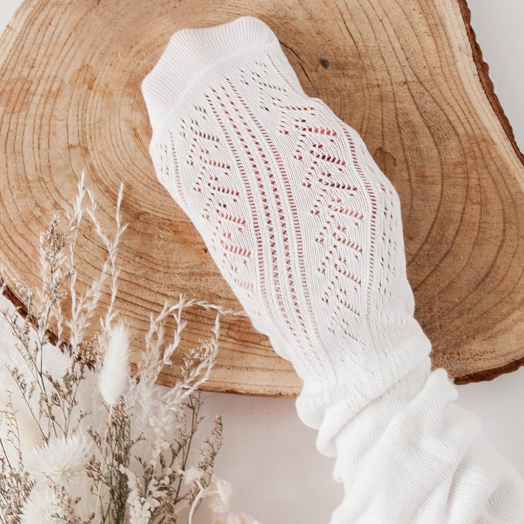 US stockist of Karibou Kids' Sweet Love special occasion mesh tights in white.