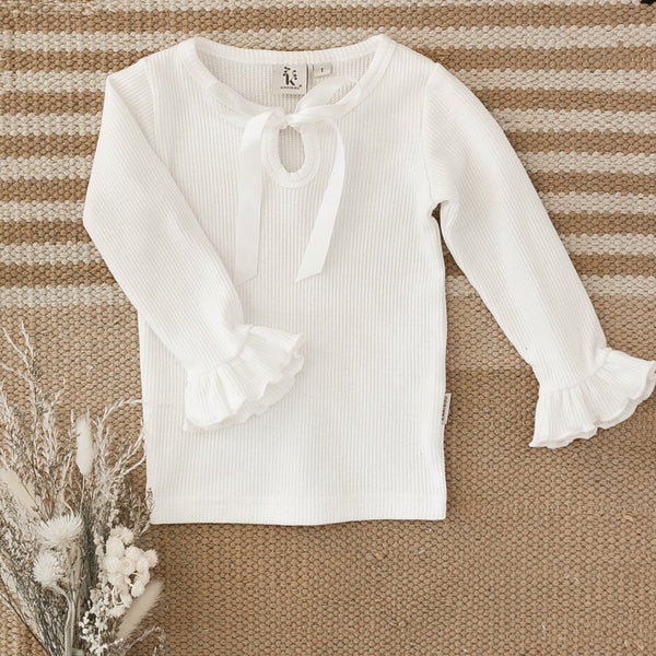 US stockist of Karibou Kids' whimsy love ruffle sleeve, cotton waffle top in snow white.  Features keyhole tie front of neck.