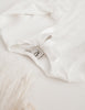US stockist of Karibou Kids' whimsy love ruffle sleeve, cotton waffle top in snow white.  Features keyhole tie front of neck.