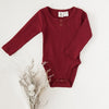 US stockist of Karibou Kids gender neutral, Storybook Red Willow long sleeve henley bodysuit in ribbed cotton blend.
