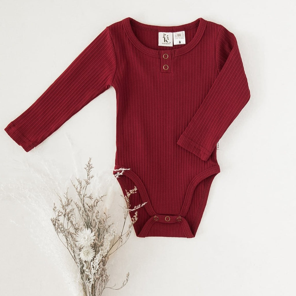 US stockist of Karibou Kids gender neutral, Storybook Red Willow long sleeve henley bodysuit in ribbed cotton blend.