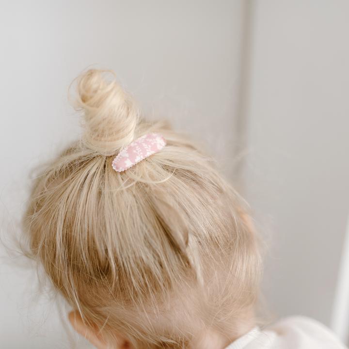 US stockist of Josie Joan's Little Mazi set of two fabric covered baby hair clips.  Gorgeous pink fabric with contrasting pale flowers and leaves.  Scalloped edging.