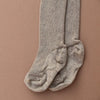 US stockist of Silly Silas gender neutral retro ribbed footed tights in Peanut blend.  Made from 100% cotton and features braces.
