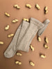 US stockist of Silly Silas gender neutral retro ribbed footed tights in Peanut blend.  Made from 100% cotton and features braces.