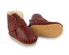 US stockist of Donsje's Burgundy classic leather  baby shoes with Mace faux fur lining.  Velcro braided fastening - soft sole under 12mths.