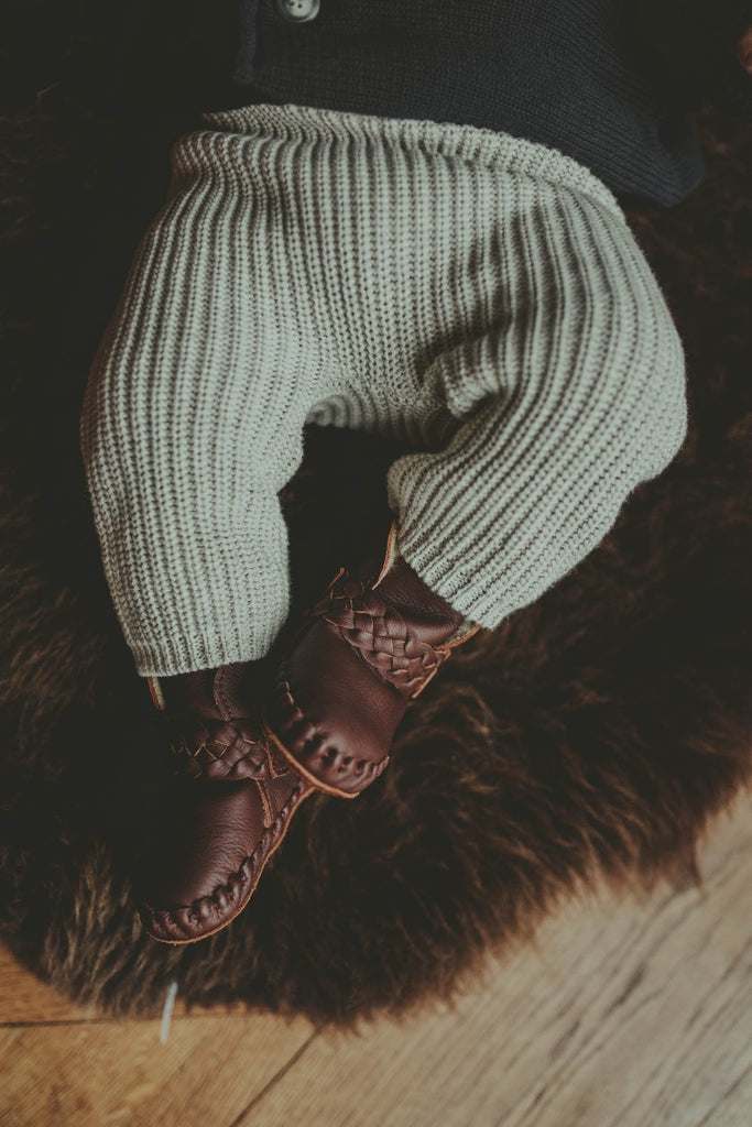 US stockist of Donsje's Burgundy classic leather  baby shoes with Mace faux fur lining.  Velcro braided fastening - soft sole under 12mths.