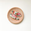 US stockist of Josie Joan's Marni set of two fabric hair clips.  Cream colored fabric with pink and orange flowers and green foilage.  Features scalloped edging.