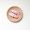US stockist of Josie Joan's Mazi set of two fabric covered hair clips.  Gorgeous pink fabric with contrasting pale flowers and leaves.  Scalloped edging.