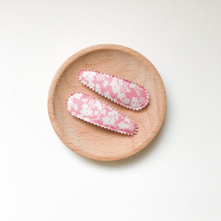 US stockist of Josie Joan's Mazi set of two fabric covered hair clips.  Gorgeous pink fabric with contrasting pale flowers and leaves.  Scalloped edging.