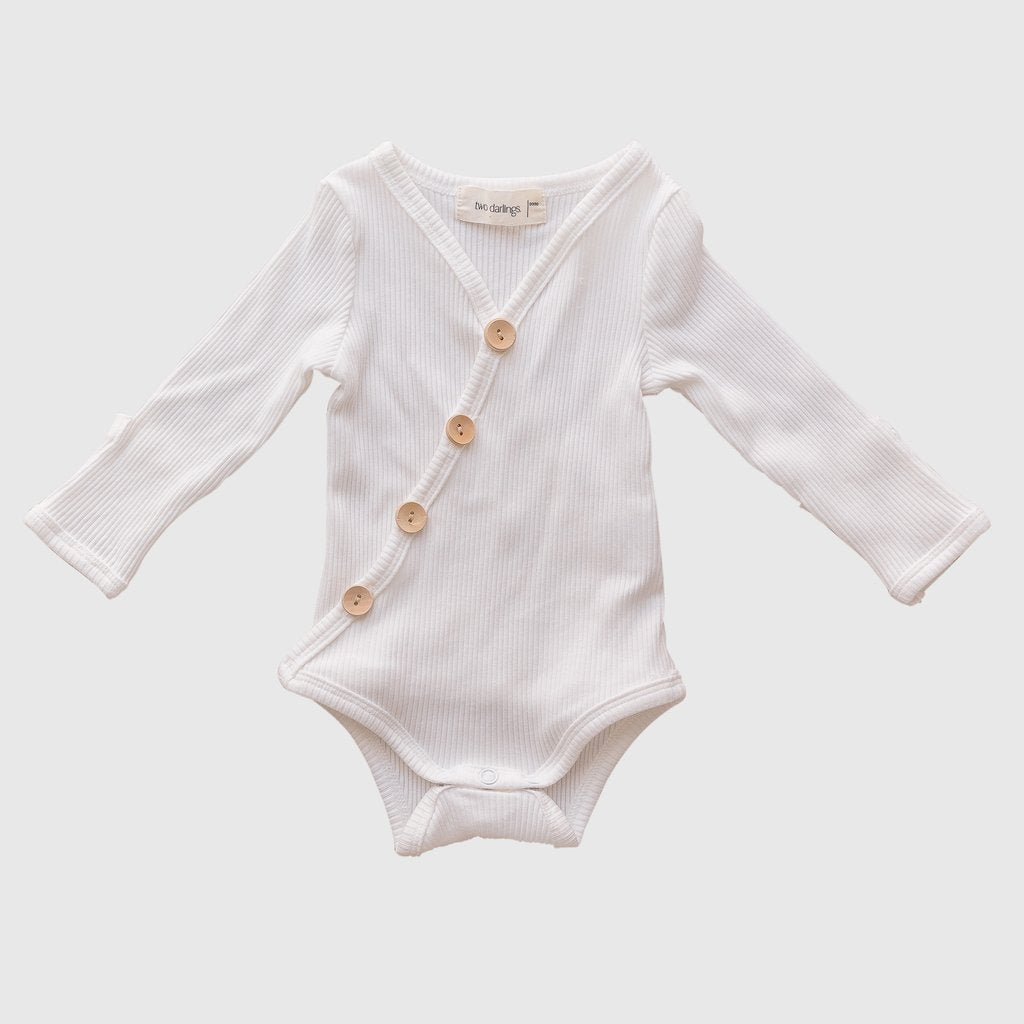 US stockist of Two Darlings gender neutral Milk stretch rib cotton bodysuit. Long Sleeves with 4 non functional wooden buttons kimono style across the front.