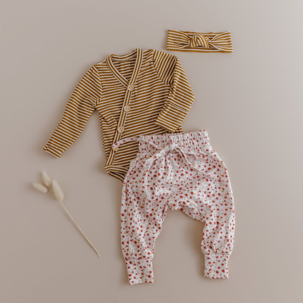 US stockist of Two Darlings gender neutral Mustard Stripe stretch rib cotton bodysuit. Long Sleeves with 4 non functional wooden buttons kimono style across the front.