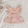 US stockist of India and Grace's Embroidered Ruffle Peplum Top in vintage pink.  Made from cotton with shell buttons at the back, ruffle sleeves and floral embroidery on the chest. 