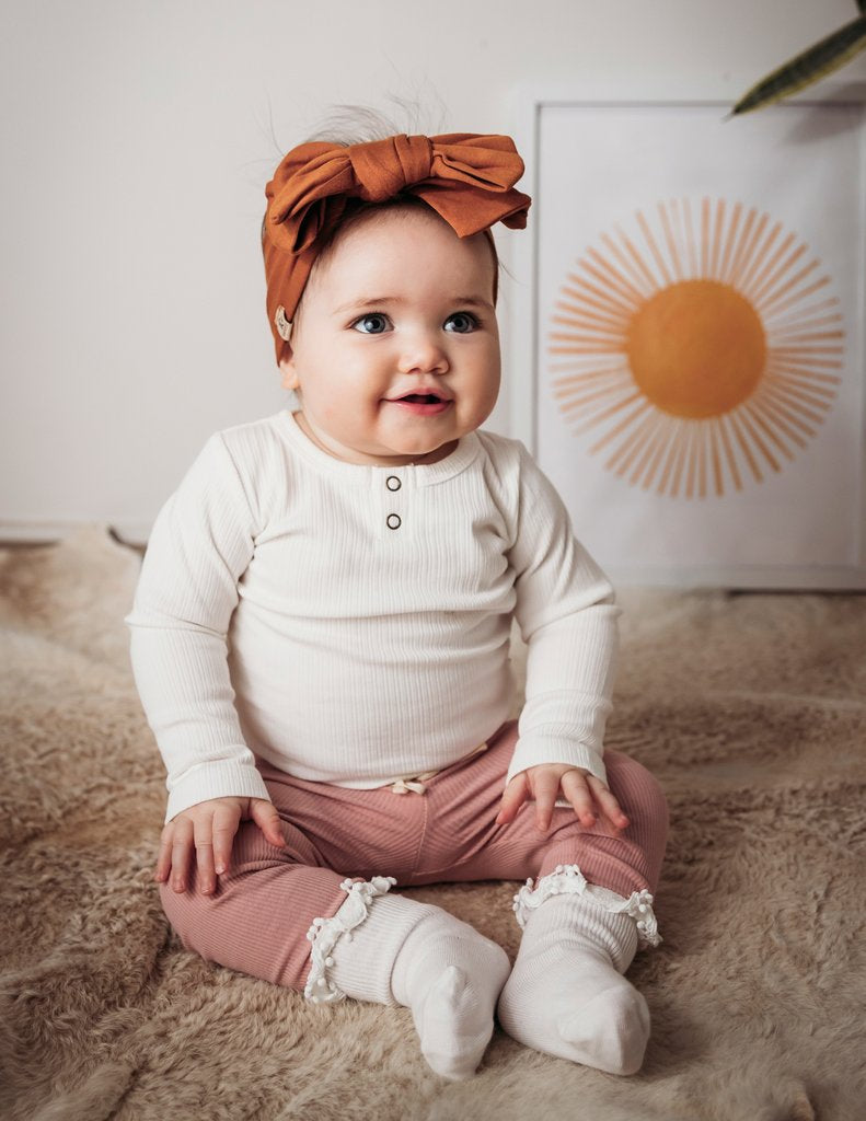 US stockist of Karibou Kid's white ankle pom pom ruffle socks.  Made from a cotton blend.