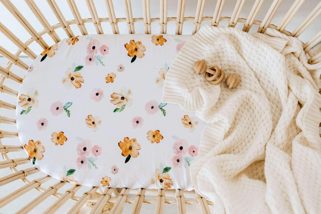 US stockist of Snuggle Hunny Kid's Poppy stretch cotton jersey bassinet sheet. White color with pink and yellow poppy print.