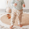 US stockist of India + Grace The Label's relaxed fit, gender neutral ribbed cotton leggings in beige.  Features contrasting cream cuffs and non functional drawstring at waist.