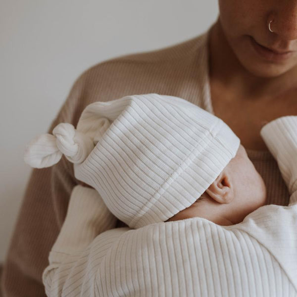 US stockist of Buck & Baa's gender neutral, organic cotton ribbed knotted hat in Milk.