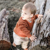 US stockist of Two Darlings gender neutral rust knit sweater.  Made from 100% cotton with two wood like buttons on the left shoulder.  Soft and stretchy.