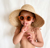 US stockist of Grech & Co's gender neutral sustainable sunglasses.  Made from recycled plastic, with round amber lens with UV 400 protection in a rust color.
