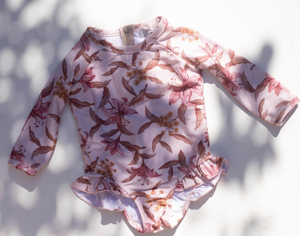 US stockist of Sukoo the Label.  Long Sleeve rashsuit made from Repreve UPF 50 + fabric.  Cream fabric with beautiful pink floral print and hidden zip at back.
