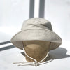 US stockist of Fini the Label's gender neutral, sailor swim hat in cream. Features elongated back for added sun protection, wide brim and chin strap. Brim is medium stiffness and can be flipped up at front. Sides can be worn buttoned up for that sailor look.  Made from nylon/spandex and is quick drying.
