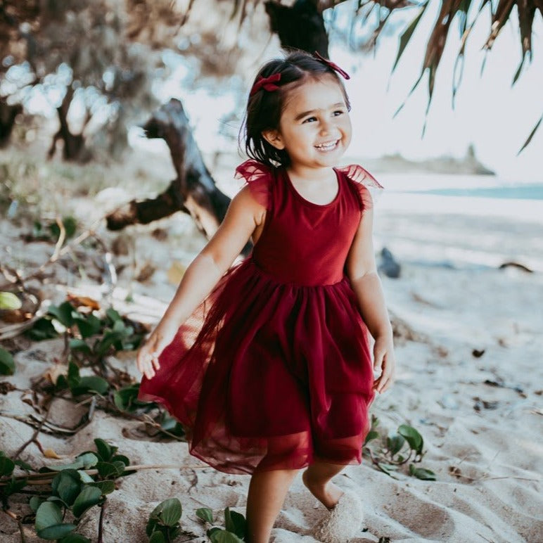US stockist of Karibou Kid's Scarlett Tutu Dress.  Made from a soft cotton blend with midi length tulle skirt.  Features open back with a big bow.
