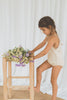 US stockist of Illoura the Label's Apricot Scout Onesie.  Made from 100% cotton in a neutral color with apricot trim.