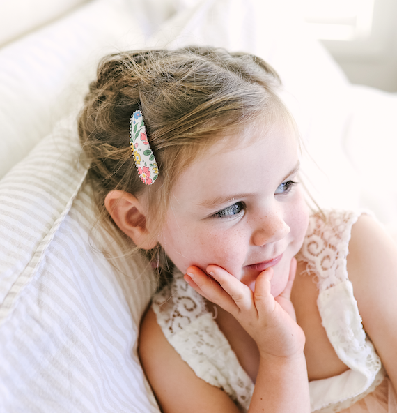 US stockist of Josie Joan's Ava fabric hair clips.  Set of two on pale fabric with beautiful yellow, blue, pink or red flowers and contrasing green leaves.  Has scalloped edges.