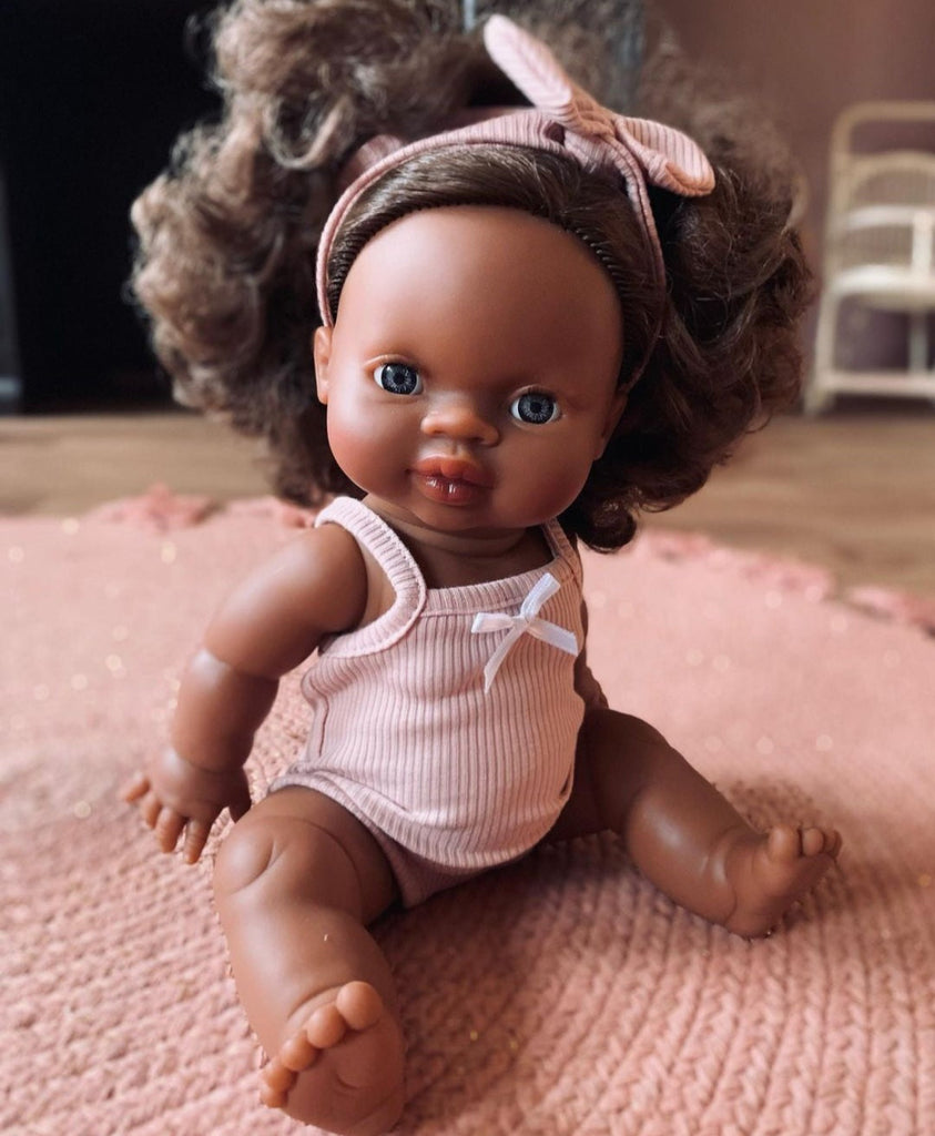 US stockist of Minikane's "Charlie" girl doll.  Measures 13" in height and has moveable limbs.  Anatomically correct and features curly brown hair, brown skin and blue eyes.