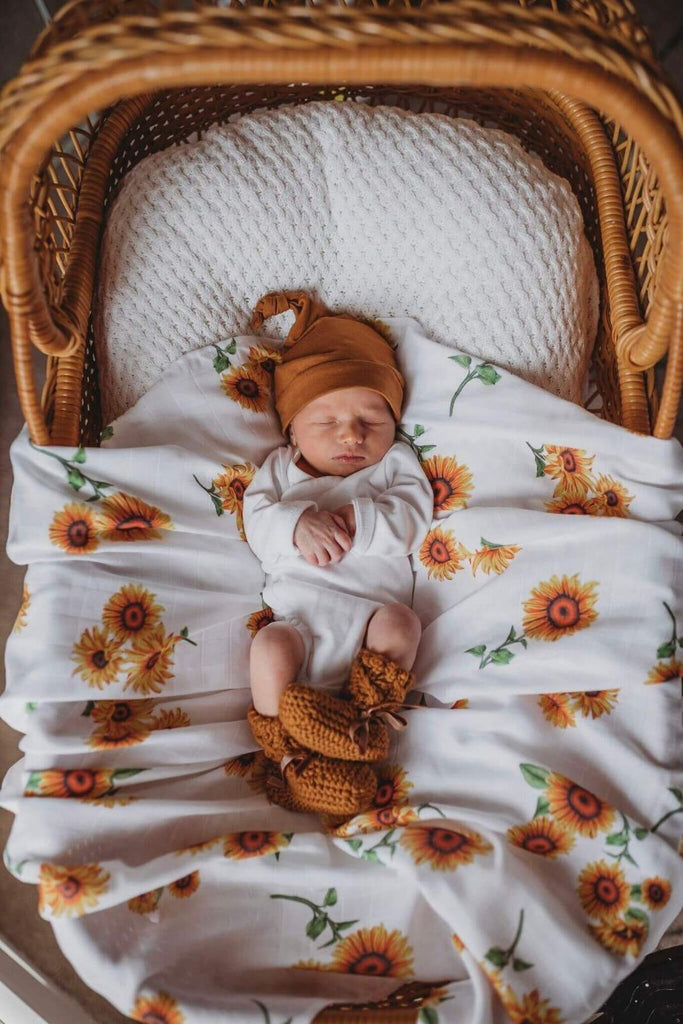 US stockist of Snuggle Hunny Kid's organic muslin wrap.  White with sunflower print.  Measures 47" x 47".