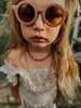 US stockist of Grech & Co's gender neutral sustainable sunglasses.  Made from recycled plastic, with round amber lens with UV 400 protection in a burlwood color.