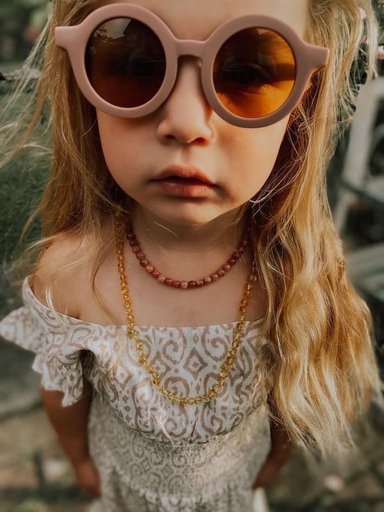 US stockist of Grech & Co's gender neutral sustainable sunglasses.  Made from recycled plastic, with round amber lens with UV 400 protection in a burlwood color.