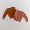 US stockist of Two Darlings gender neutral rust knit sweater.  Made from 100% cotton with two wood like buttons on the left shoulder.  Soft and stretchy.