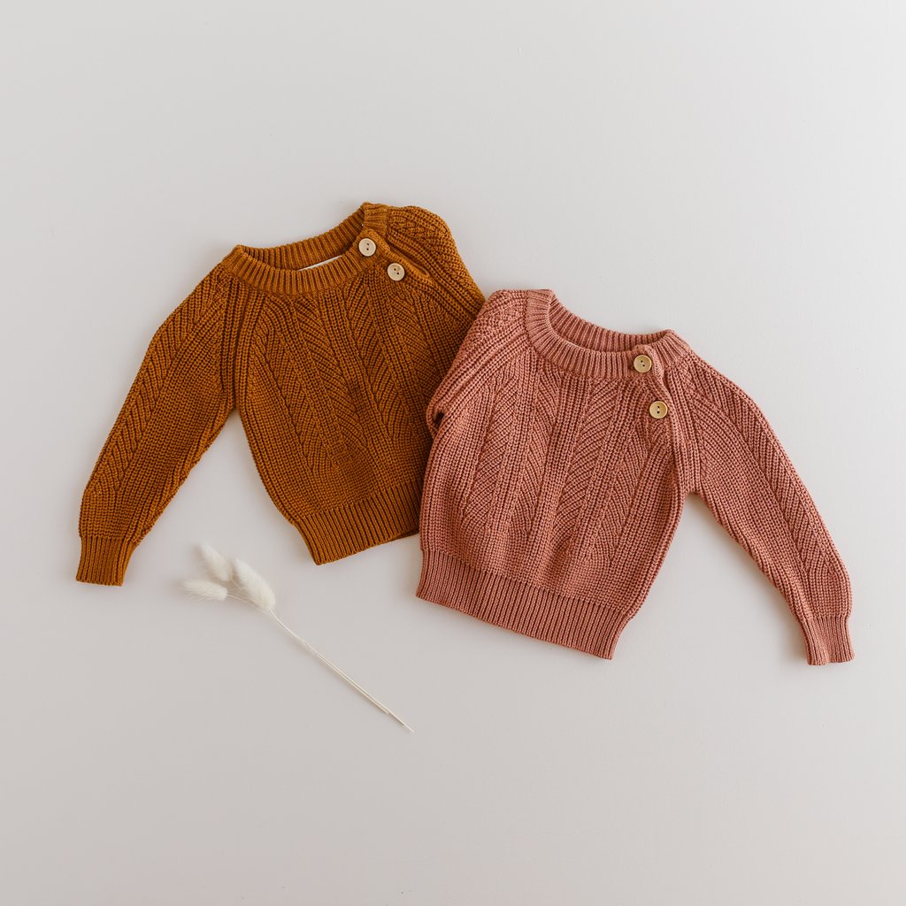 US stockist of Two Darlings gender neutral rust knit sweater.  Made from 100% cotton with two wood like buttons on the left shoulder.  Soft and stretchy.