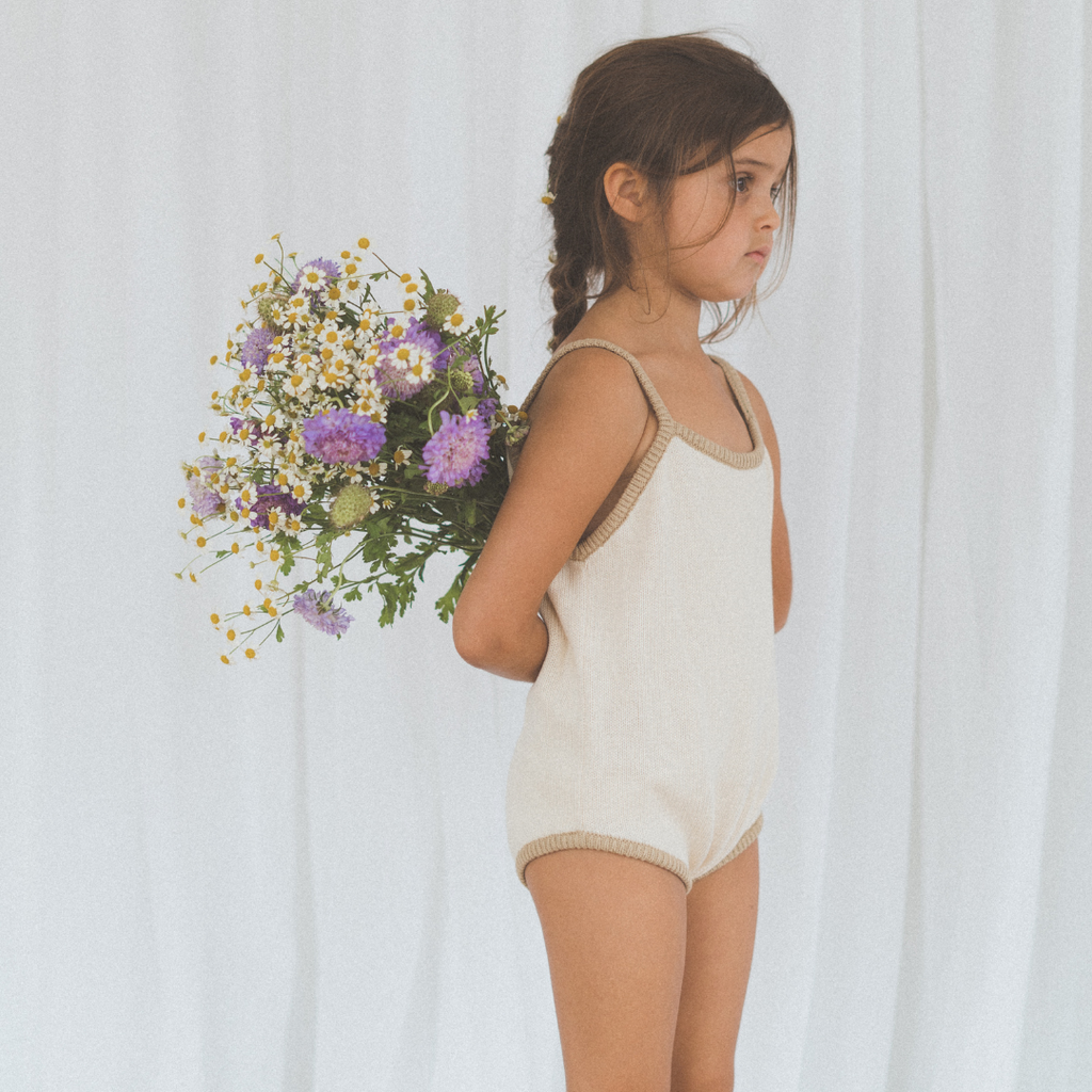 US stockist of Illoura the Label's Olive Scout Onesie.  Made from 100% cotton in a neutral color with olive trim.