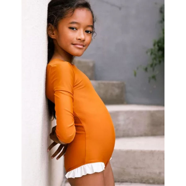 US stockist of Canopea's long sleeved, Misha Sunsuit in Sand.
