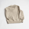 US stockist of Five O' Six's gender neutral "Bone" shawl neck sweater made from 100% merino wool.