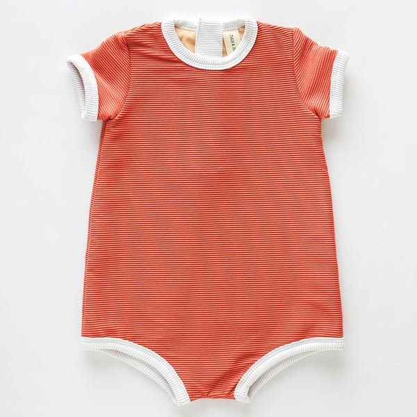The US stockist of Zulu & Zephyr Mini Rib Onesie in Plum.  A loose fit gender neutral style made from sustainable ECONYL UPF 50+ fabric.  Short sleeved with contrasing back zipper and binds.  Fully lined.